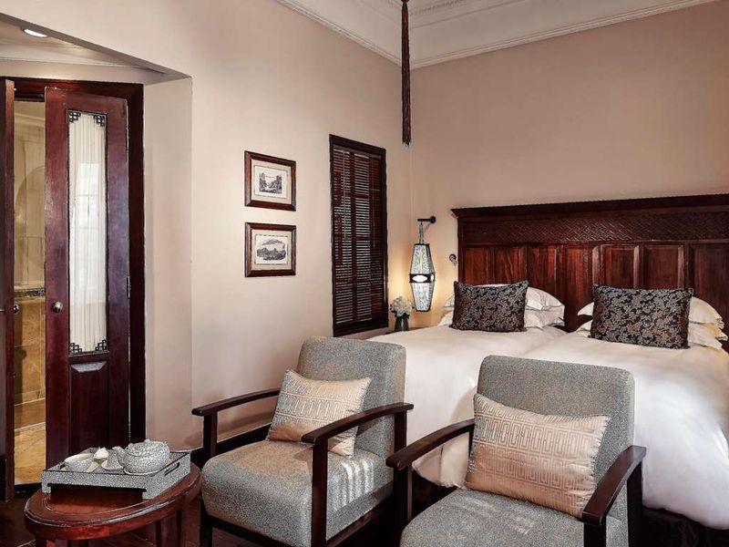 Bedroom with dark wood at Sofitel Legend Metropole Hanoi