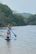 a woman and child on a paddle board