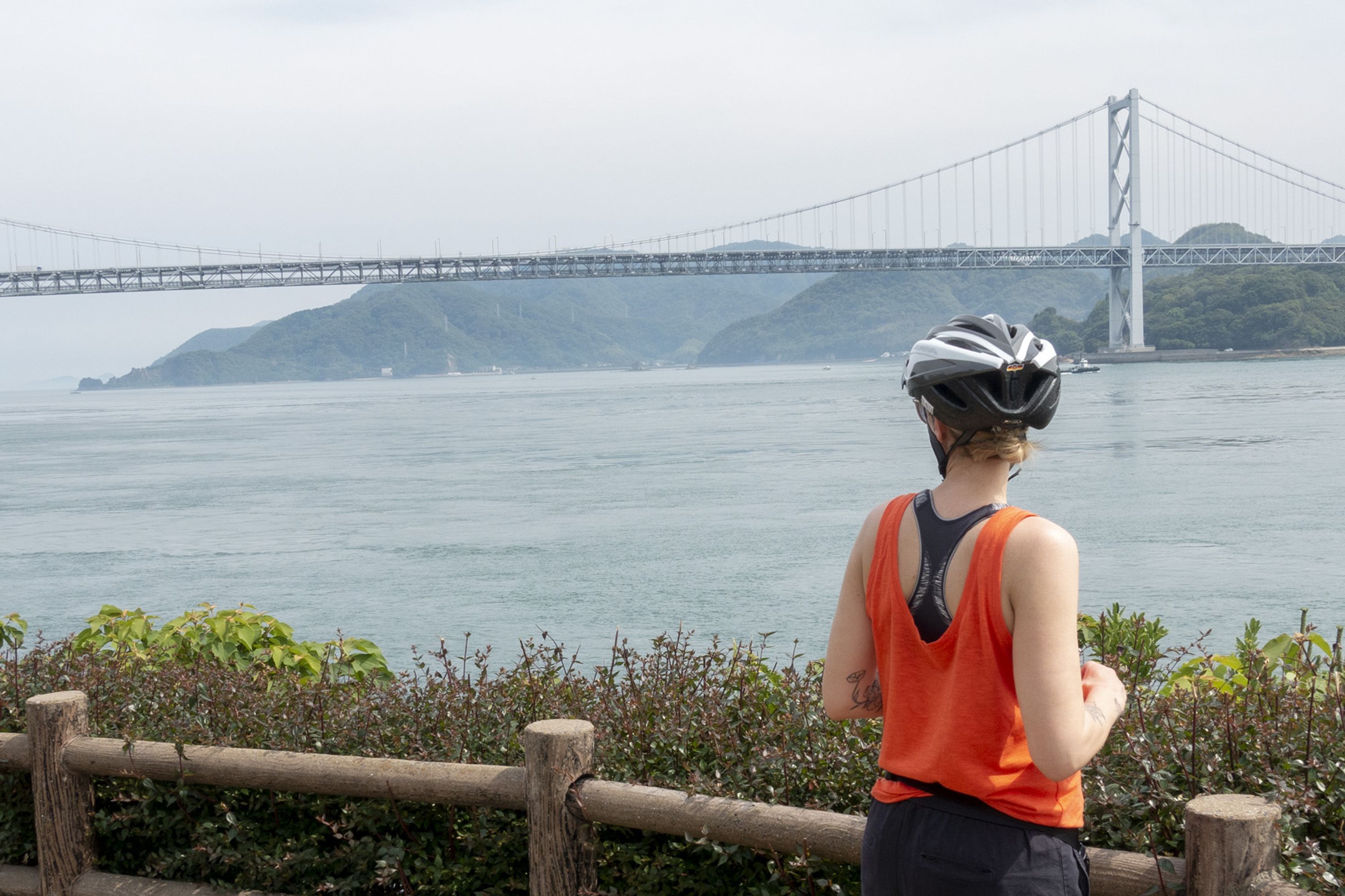 cycling holiday in japan woman looking out at bridge