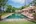 a pool with lounge chairs and a building