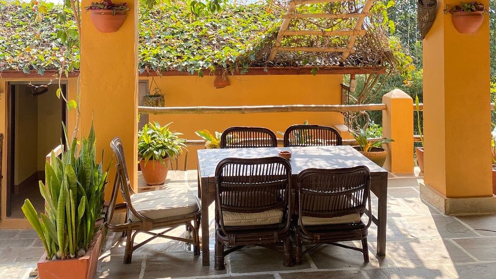 Table and chairs on a sheltered terrace at Summit River Lodge