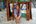 a woman sitting in sand with trash cans behind her