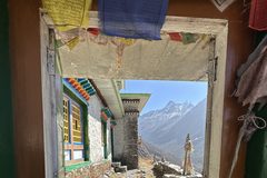 a doorway with a view of mountains and blue sky