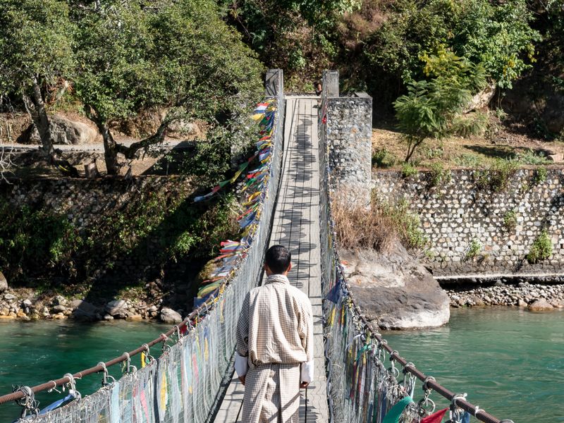 Man walking on bridge over the river