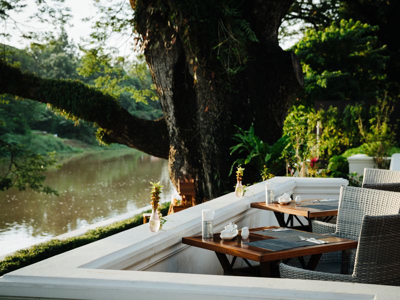 Tables by the riverside at Na Nirand