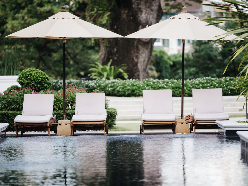 Pool with sun loungers at Na Nirand