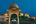 a couple sitting at a table in front of a pond