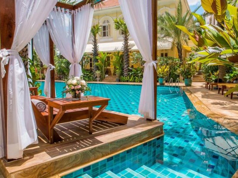 Pool and sun lounger at palace Gate Hotel