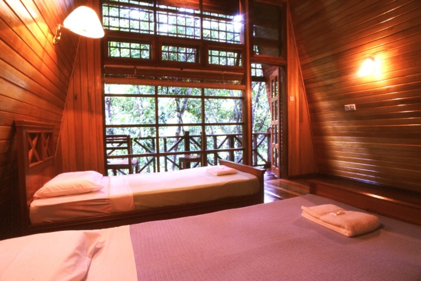 Wooden cabin with twin beds at Tabin Wildlife Resort