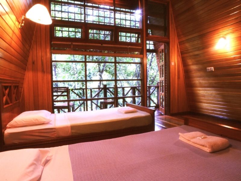 Wooden cabin with twin beds at Tabin Wildlife Resort