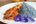 a plate of food with purple flowers