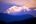 a snowy mountain with trees in the background