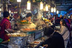 a group of people at a food stand