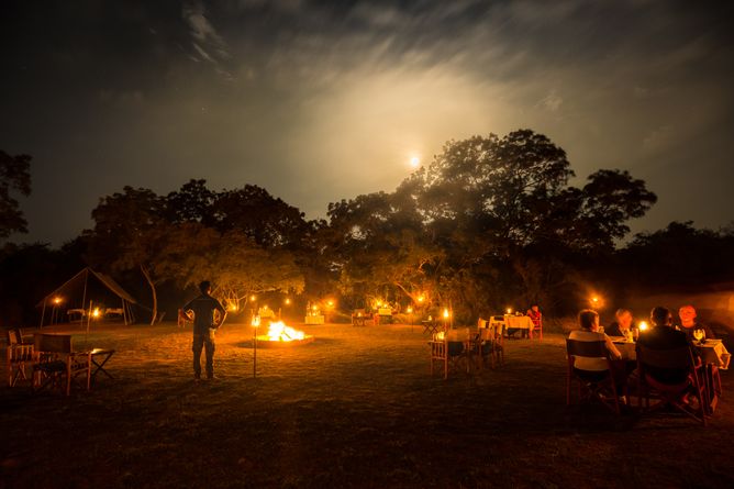 Discussing the day's activities around the camp fire
