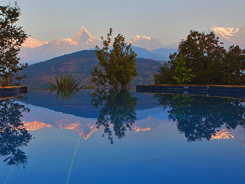 Pool reflecting clouds at Tiger Mountain Lodge