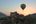 a hot air balloon flying over a city