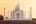 a white building with domes and towers with Taj Mahal in the background