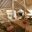 a room with a thatched roof and chairs