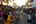 a crowd of people walking down a street