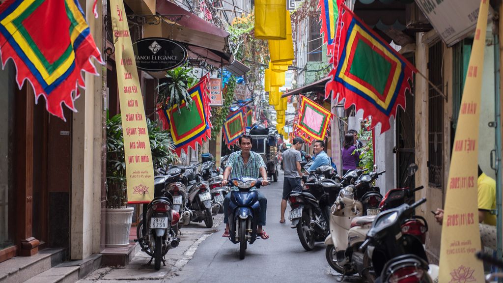 Man on a scooter riding through Hanoi