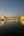 a body of water with buildings and lights with Harmandir Sahib in the background