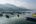boats in a lake with mountains in the background
