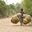 a boy riding a bicycle with baskets on it