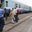a group of people standing next to a train
