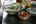 a bowl of soup with chopsticks and a bowl of vegetables
