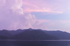 a large body of water with mountains in the background