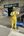 a man wearing yellow clothes and holding a phone