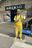 a man wearing yellow clothes and holding a phone