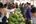 a woman buying vegetables at a market