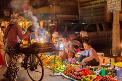 a woman selling food on a street
