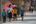 a group of people walking down a street with umbrellas