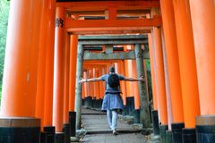 a person walking through an orange archway