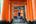 a person walking through an orange archway