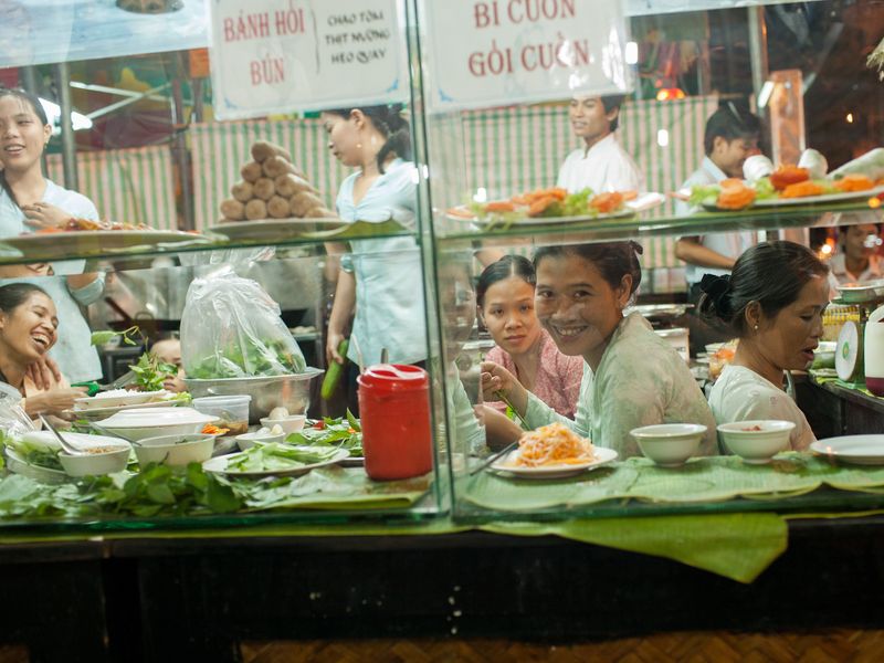 Ladies smiling sitting by the window at a Vietnam restaurant