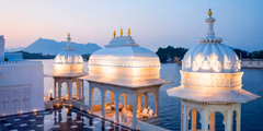 a white gazebo next to water