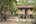 a wooden house on stilts in the middle of a forest