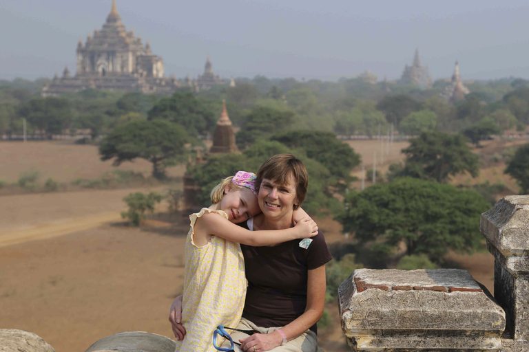 a woman and child hugging on a ledge