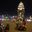 a group of people sitting on motorcycles in front of a tall tower