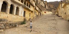Boy walking on quiet street in India