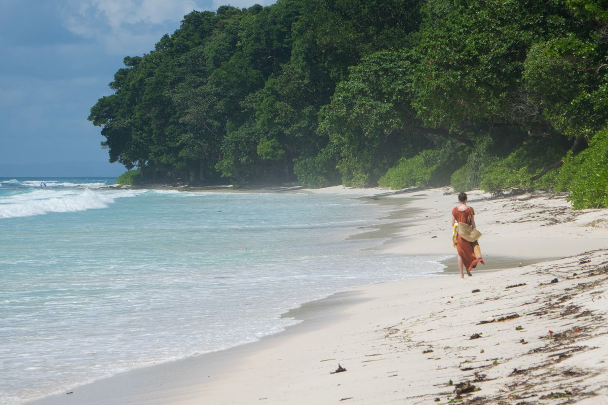 Woman walking along beach in the Andamans