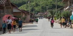 a group of people walking on a road