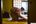 a woman in a robe bending over a bed