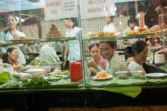 a group of people sitting at a counter