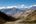 a valley with mountains in the background