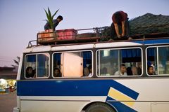 a bus with people on the roof