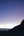 a silhouette of a mountain with a sunset in the background